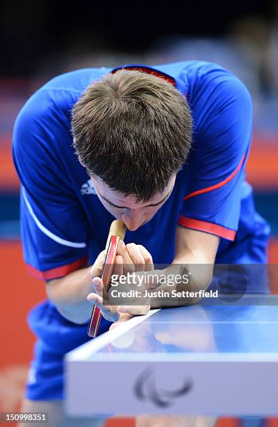 Pascal Pereira-Leal of France prepares to serve against Lucas Maciel of Brazil in the Preliminary Round of the Men's Singles Table Tennis Class 11...