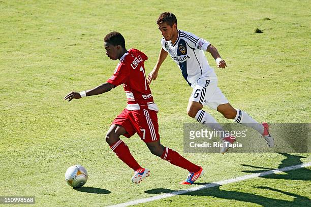 Fabian Castillo of FC Dallas dribbles the ball while being defended by Hector Jimenez of Los Angeles Galaxy during the MLS match at The Home Depot...