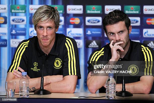 Chelsea's Spanish forward Fernando Torres speaks neaer Chelsea's Spanish midfielder Juan Mata during a press conference on the eve of the UEFA Super...