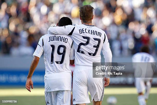 David Beckham of Los Angeles Galaxy hugs Juninho of Los Angeles Galaxy during the MLS match against FC Dallas at The Home Depot Center on August 26,...