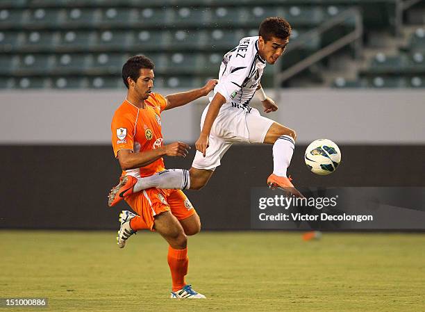 Hector Jimenez of the Los Angeles Galaxy plays the ball from Justin Fojo of the Puerto Rico Islanders during the group stage CONCACAF Champions...