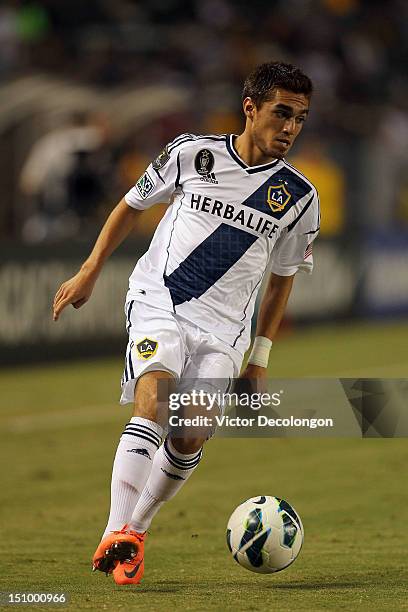 Hector Jimenez of the Los Angeles Galaxy paces the ball on the attack during the group stage CONCACAF Champions League match against the Puerto Rico...