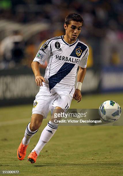 Hector Jimenez of the Los Angeles Galaxy paces the ball on the attack during the group stage CONCACAF Champions League match against the Puerto Rico...
