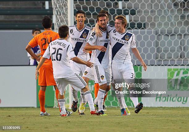 Tommy Meyer of the Los Angeles Galaxy celebrates his goal with teammates Jack McBean and Michael Stephens in the first half during the group stage...