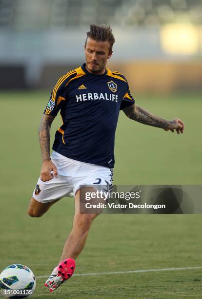 David Beckham of the Los Angeles Galaxy warms up prior to their group stage CONCACAF Champions League match against the Puerto Rico Islanders at The...