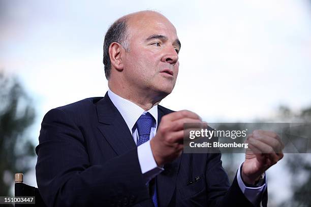 Pierre Moscovici, France's finance minister, gestures during a Bloomberg Television interview at the Mouvement des Enterprises de France conference...