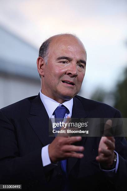 Pierre Moscovici, France's finance minister, gestures during a Bloomberg Television interview at the Mouvement des Enterprises de France conference...