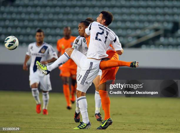 Tommy Meyer of the Los Angeles Galaxy and Nick Addlery of the Puerto Rico Islanders vie for the ball during the group stage CONCACAF Champions League...