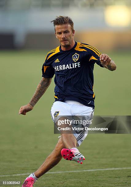 David Beckham of the Los Angeles Galaxy warms up prior to their group stage CONCACAF Champions League match against the Puerto Rico Islanders at The...