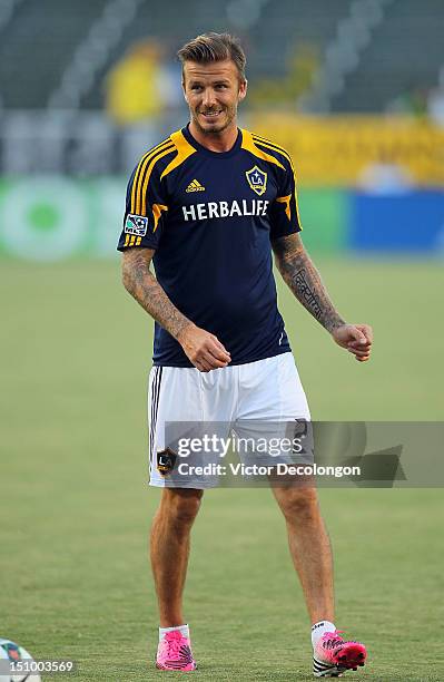 David Beckham of the Los Angeles Galaxy looks on during warm-up prior to their group stage CONCACAF Champions League match against the Puerto Rico...