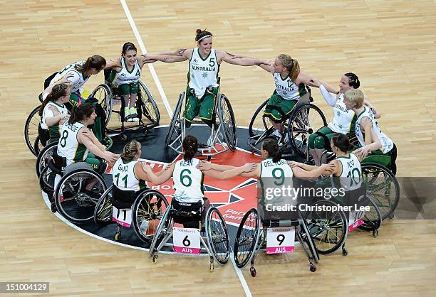 The Australia women's wheelchair basketball team huddle together as they celebrate their victory during the Group A Preliminary Women's Wheelchair...