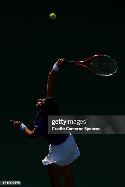 Carla Suarez Navarro of Spain serves during her women's singles second round match against Agnieszka Radwanska of Poland on Day Four of the 2012 US...