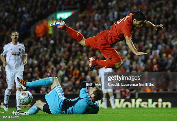 Luis Suarez of Liverpool collides with Jamie Macdonald of Hearts during the UEFA Europa League play-off round second leg between Liverpool and Hearts...