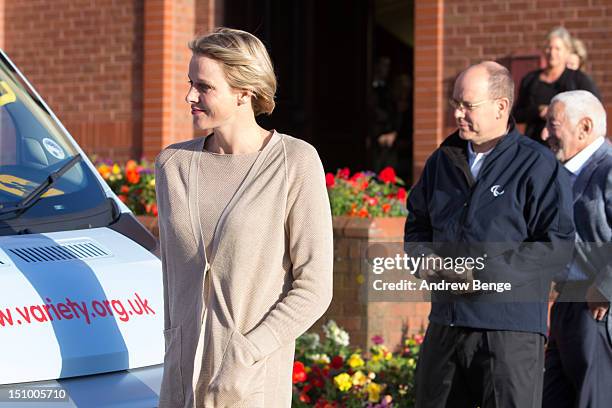 Prince Albert II of Monaco and Princess Charlene of Monaco present a Variety Children's Charity sunshine coach to pupils and staff from Greenhill...