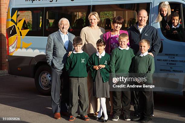 Prince Albert II of Monaco and Princess Charlene of Monaco present a Variety Children's Charity sunshine coach to pupils and staff from Greenhill...