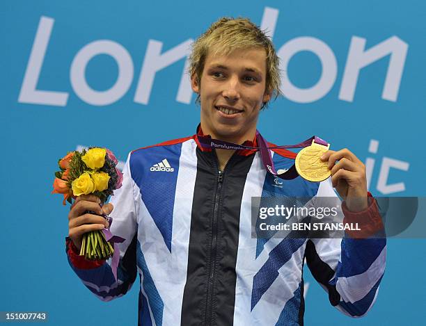 Britain's gold medallist Jonathan Fox poses on the podium during the victory ceremony for the men's 100m backstroke - S7 final during the London 2012...