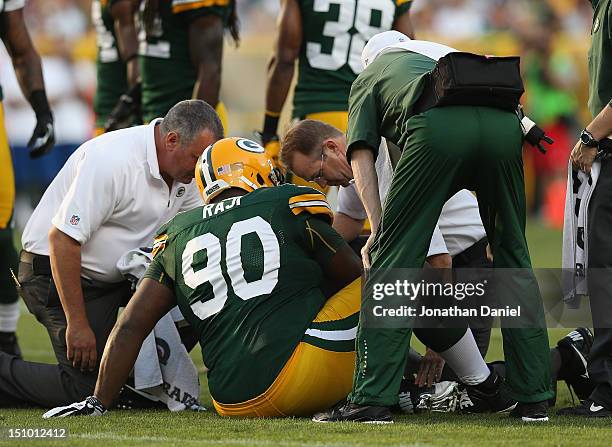 Raji of the Green Bay Packers is looked after by doctors early against the Kansas City Chiefs during a preseason game at Lambeau Field on August 30,...