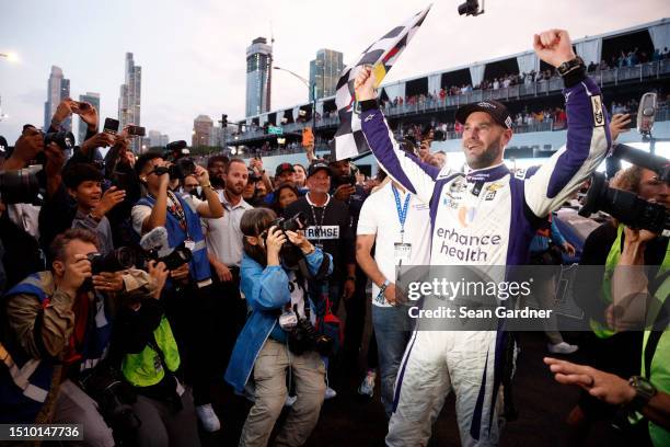Shane Van Gisbergen, driver of the Enhance Health Chevrolet, celebrates with the checkered flag after winning the NASCAR Cup Series Grant Park 220 at...
