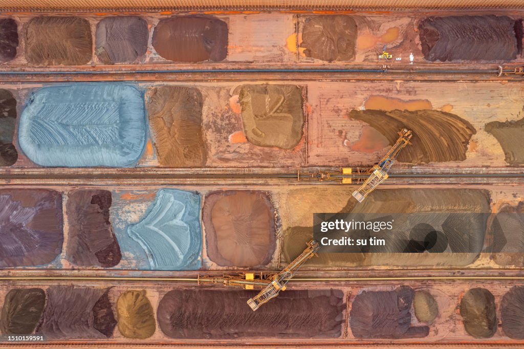 Vertical aerial view of pier with stacked ore raw materials