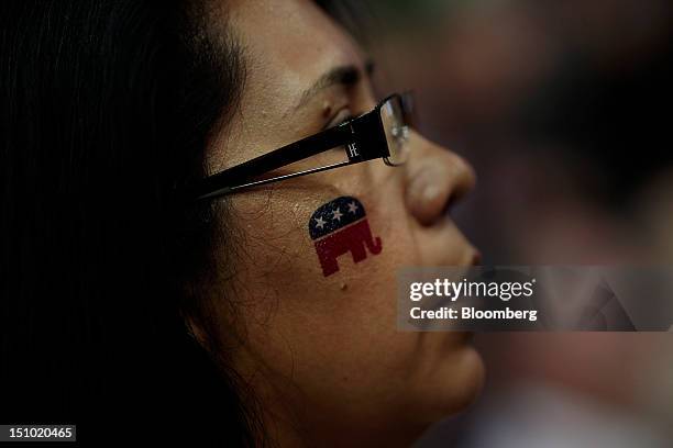 Delegate wears an elephant mascot temporary tattoo on her face at the Republican National Convention in Tampa, Florida, U.S., on Thursday, Aug. 30,...