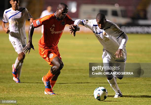 Houston Dynamo player Je-Vaughn vies for the ball with Juan Carlos Garcia of Olimpia their Concacaf Champion League fotball match at the Tiburcio...