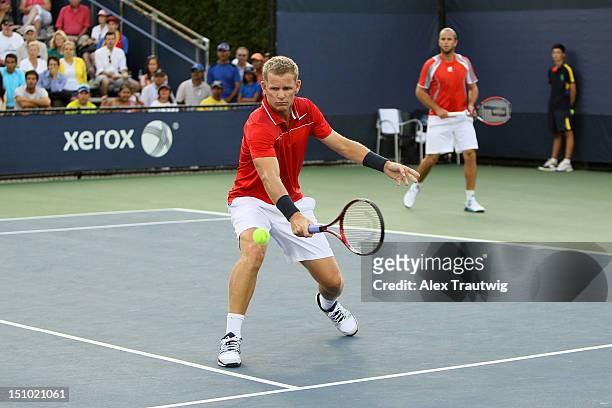 Mark Knowles of Bahamas returns a shot next to his partner Xavier Malisse of Belgium during their men's doubles first round match against Pablo...