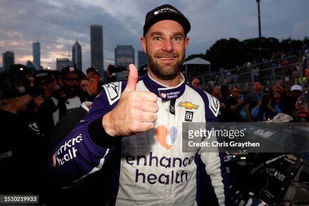 Shane Van Gisbergen, driver of the Enhance Health Chevrolet, gives a thumbs up in victory lane after winning the NASCAR Cup Series Grant Park 220 at...