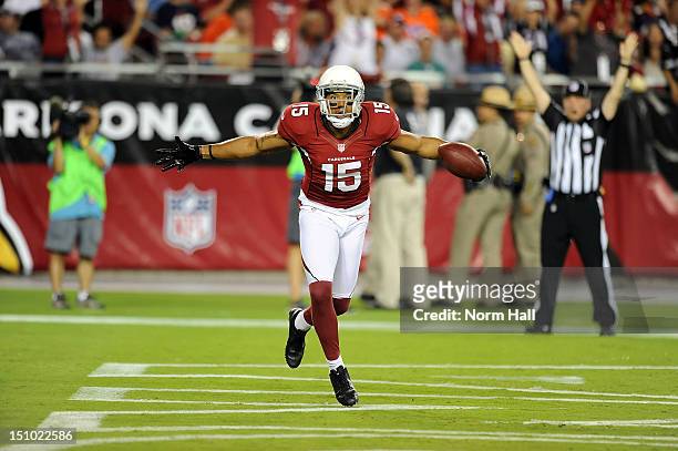 Michael Floyd of the Arizona Cardinals celebrates after catching a touchdown against the Denver Broncos at University of Phoenix Stadium on August...