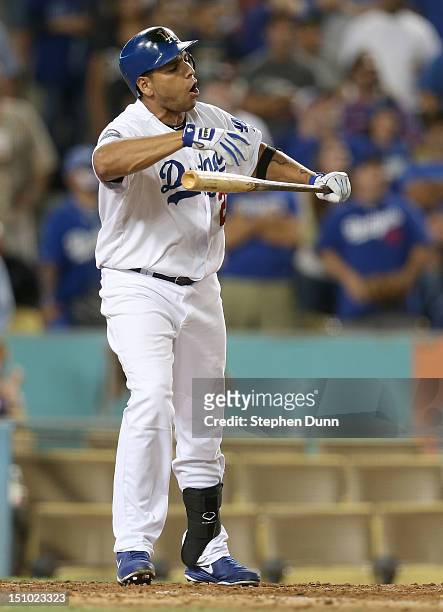 Juan Rivera of the Los Angeles Dodgers reacts after popping out with men on base for the last out of the game against the Arizona Diamondbacks on...