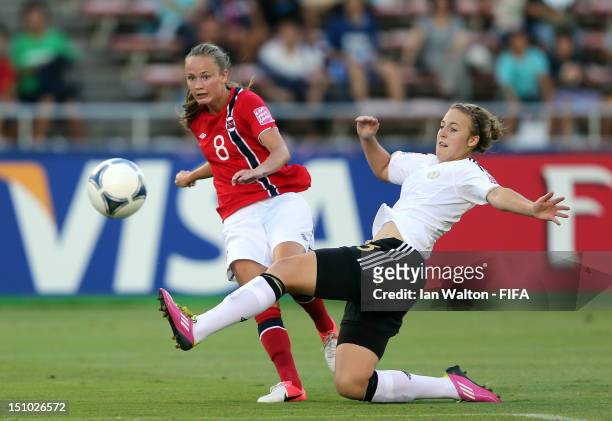 Caroline Hansen of Norway is tackled by Carolin Simon of Germany during the FIFA U-20 Women's World Cup Quarter-Final match between Germany and...