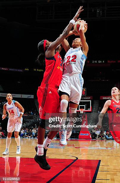 Armintie Price of the Atlanta Dream drives to the basket against Michelle Snow of the Washington Mystics at Philips Arena on August 30, 2012 in...