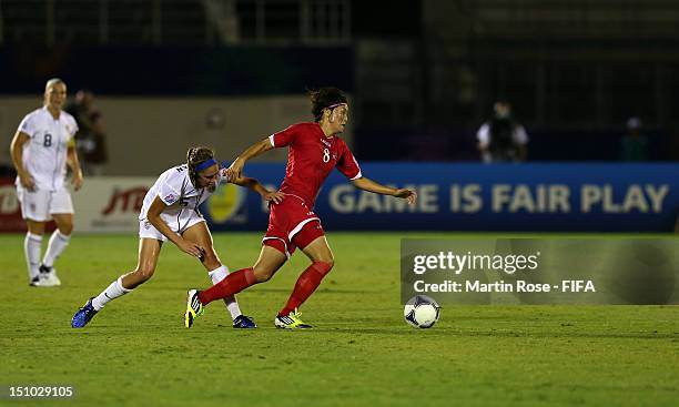 Myong Hwa Jon of Korea DPR and Morgan Brian of USA battle for the ball during the FIFA U-20 Women's World Cup Japan 2012, Quarter Final match between...