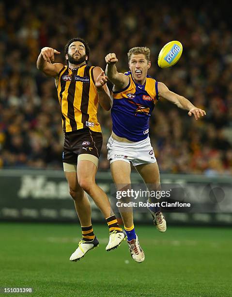 Jordan Lewis of the Hawks and Adam Selwood of the Eagles challenge eachother for the ball during the round 23 AFL match between the Hawthorn Hawks...