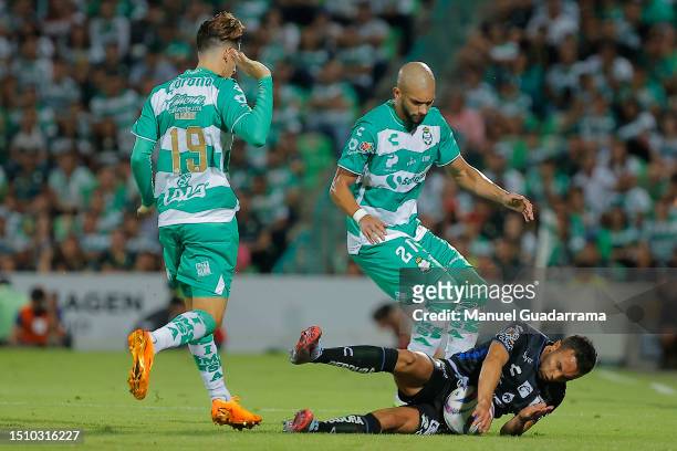Emanuel Gularte of Queretaro fights for the ball with Santiago Muñoz and Matheus Doria of Santos during the 1st round match between Santos Laguna and...