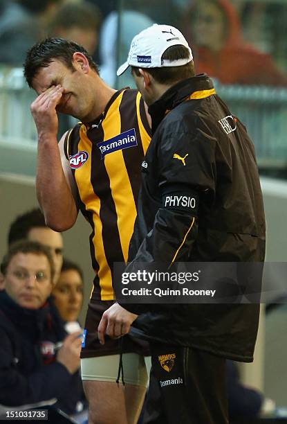 Brent Guerra of the Hawks reacts after injuring his hamstring during the round 23 AFL match between the Hawthorn Hawks and the West Coast Eagles at...