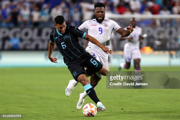 Bryan Acosta of Honduras and Duckens Nazon of Haiti battle for control of the ball during the second half of the Concacaf Gold Cup match at Bank of...