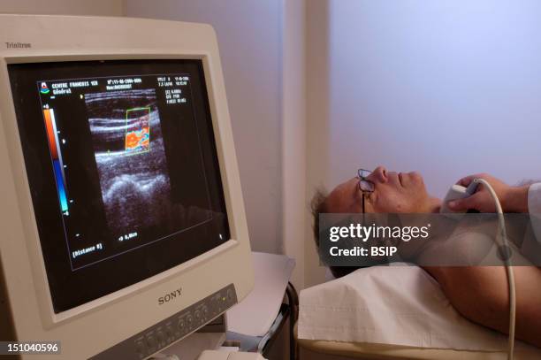 Model And Doctor. Doppler Ultrasound Scan Of Carotid Arteries. Imt Index Intima Media Thickness Calculates The Degree To Which Plaque May Be...