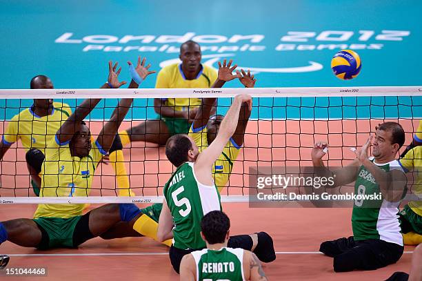 Giovani De Freitas of Brazil passes the ball to teammate Daniel Silva during the Men's Sitting Volleyball Preliminaries Pool B match between Brazil...