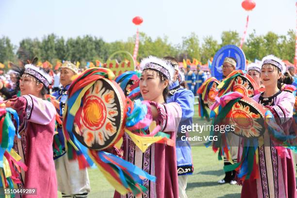 Hezhe people in traditional costumes dance during the 11th 'Wurigong' Festival, meaning fun day or sports meeting, on July 2, 2023 in Fuyuan, Jiamusi...