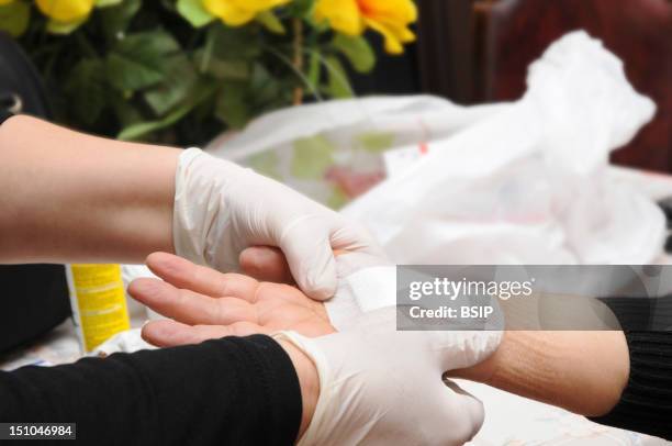 Independent Nurse, In Venissieux, France. Dressing On A Patient Suffering From Carpal Tunnel Syndrome.