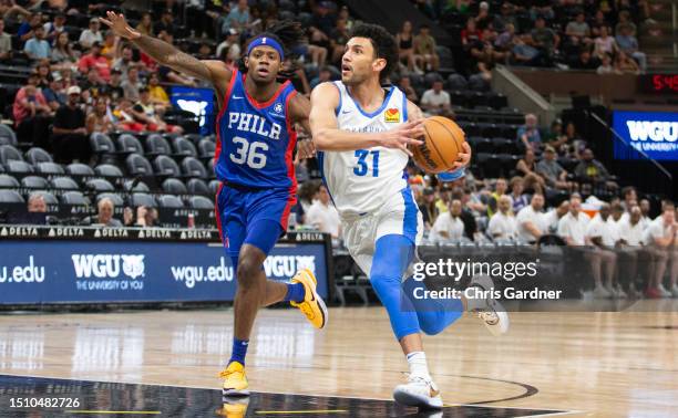 Hunter Maldonado of the Oklahoma City Thunder drives past DJ Steward of the Philadelphia 76ers during the first half of their NBA Summer League game...