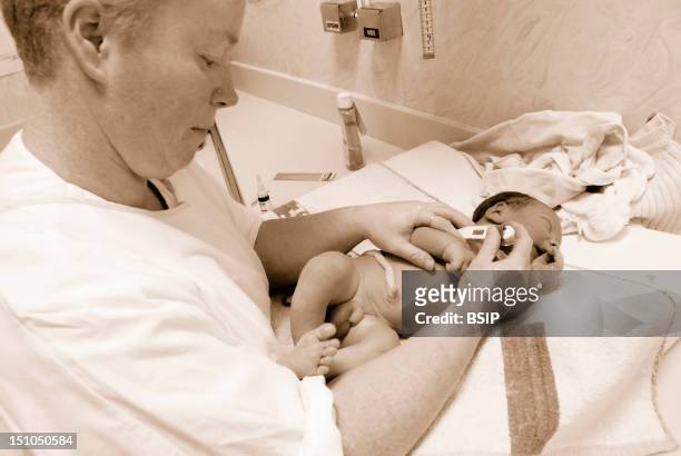 Photo Essay From Hospital. Maternity Of The Hospital Center Rene Pleven Dinan Cotes D'Armor 22, France. Newborn Baby Boy Child Care Aid Measuring The...