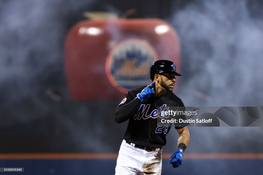 Tommy Pham of the New York Mets rounds the bases after hitting a