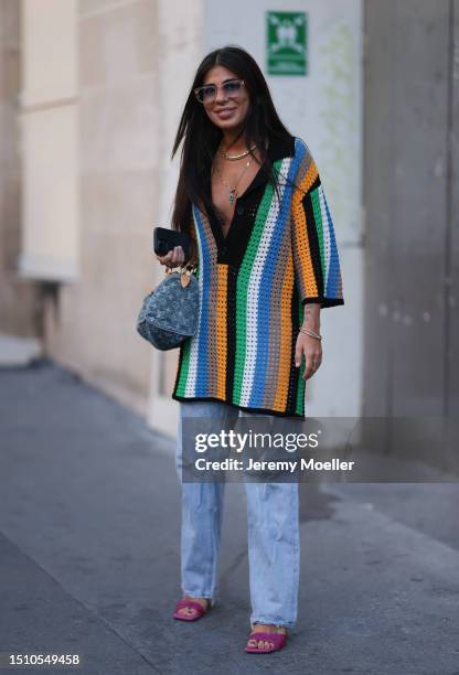 Héloïse Salessy is seen wearing rose colored sunnies, gold necklace, Louis Vuitton Speedy bag in denim, crochered outside Marine Serre show during...