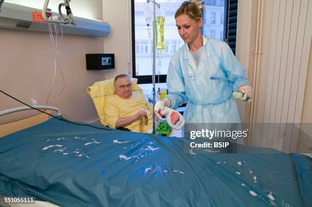 Photo Essay At Saint Louis Hospital, Paris, France. Department Of Endocrinology. Washing Of The Anti Bed Sore Mattress Before Changing The Bedding.