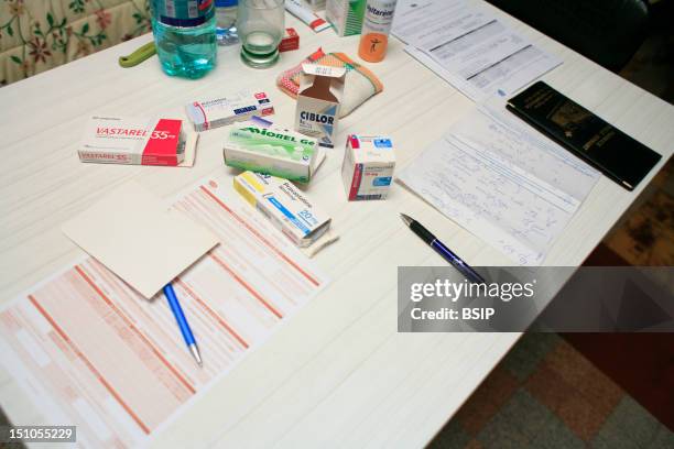 Home Consultation Of A General Practitioner. Hazebrouck, France. On The Table; Vastarel Active Substance Trimetazidine, Antianginal Drug, Miorel...