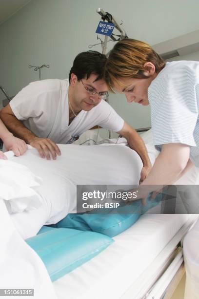 Photo Essay From Hospital. Geriatrics Unit At The Sebastopol Hospital In Reims, France. Female Nurse's Aide And Male Nurse.