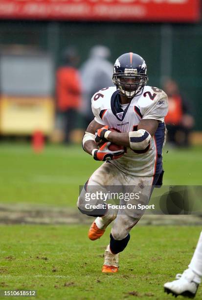 Clinton Portis of the Denver Broncos carries the ball against the Oakland Raiders during an NFL football game on November 30, 2003 at the Oakland...