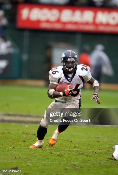 Clinton Portis of the Denver Broncos carries the ball against the Oakland Raiders during an NFL football game on November 30, 2003 at the Oakland...