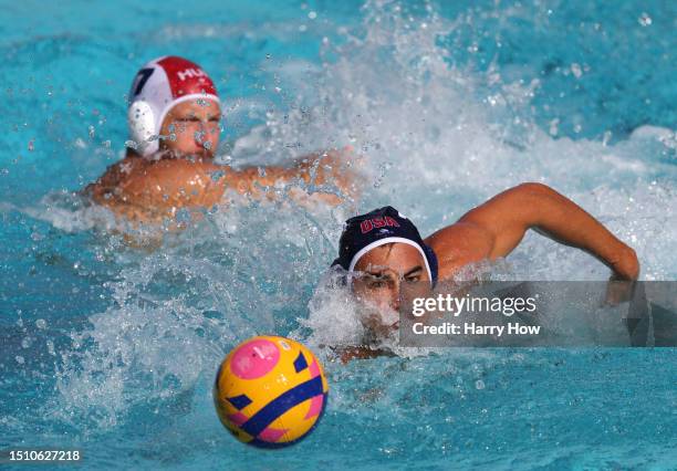 Johnny Hooper of the United States swims after the ball in front Gergo Zalanki of Team of Romania in a 14-13 win during the bronze medal match in the...
